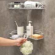 a person is holding a shower caddy in a bathroom