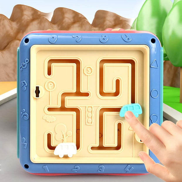 a hand is pointing at a maze board
