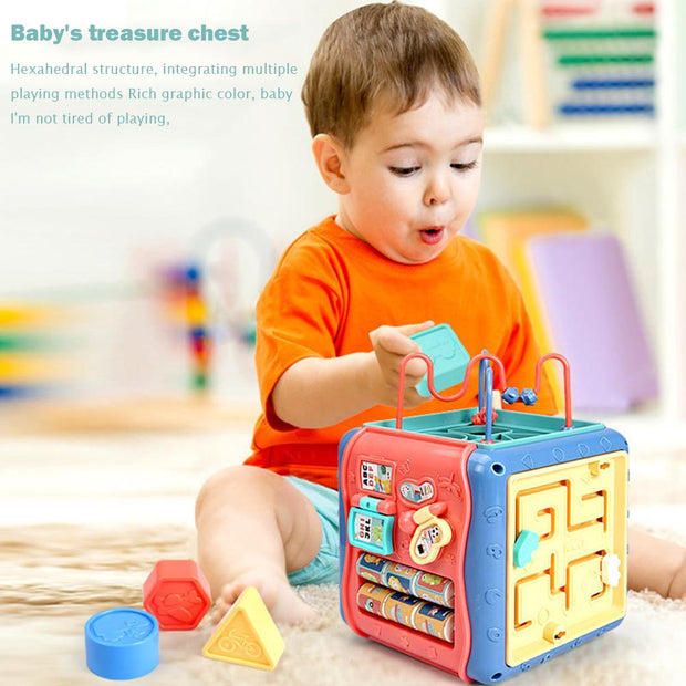 a young boy playing with a baby's toy chest