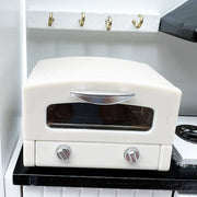 a white stove top oven sitting on top of a counter