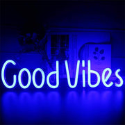 a blue neon sign that says good vibes
